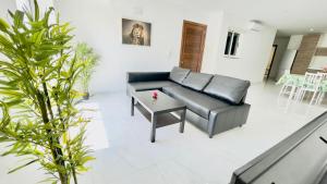 a living room with a couch and a table at Peaman Court in Marsaskala