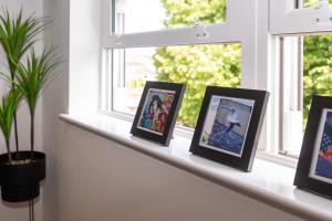 a window sill with framed pictures on it at Dawson House in Southampton +9 photos