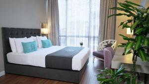a bedroom with a bed and a large window at Homey AirPort Hotel in Arnavutköy