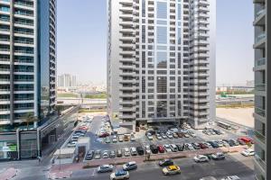 an aerial view of a parking lot in the middle of two tall buildings at Frank Porter - TECOM in Dubai