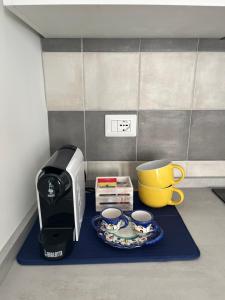 a coffee maker and a toaster and two cups at Mana House in Maiori
