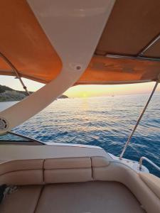 a view from the back of a boat with the sun setting at Blaško apartment in Izola