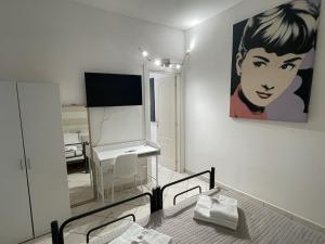 a bedroom with a table and a painting on the wall at La Casetta in La Spezia