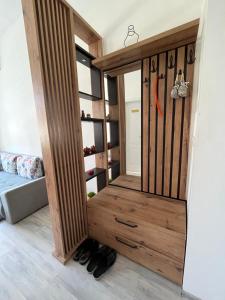 a room with a wooden closet with shoes in it at The City Block - Free Parking in Sarajevo