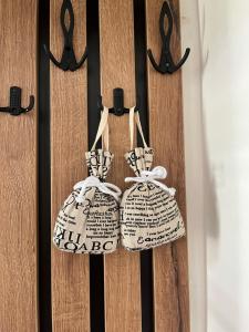 a pair of shoes hanging on a wooden door at The City Block - Free Parking in Sarajevo