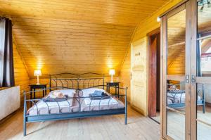 a bedroom with two beds in a wooden room at Ferienblockhaus Glocker - Hof in Leibertingen