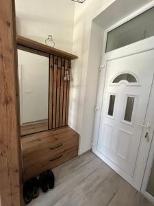 a hallway with a white door and a pair of shoes at The City Block - Free Parking in Sarajevo