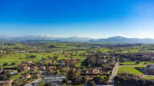 an aerial view of a small town with mountains in the background at Somo Bungalow Resort - Camping Latas in Somo