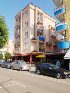 a group of cars parked in front of a building at Guest House Nedelchevi in Primorsko