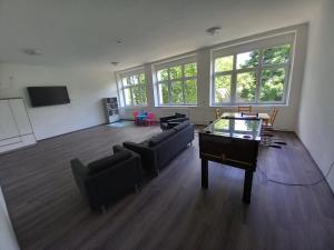 an empty living room with a piano and couches at Márianosztrai Zarándokszálláshely in Márianosztra