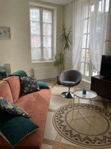 a living room with a couch and a chair at Domaine de Croix en Sologne in Neuvy-sur-Barangeon