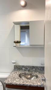 a bathroom counter with a sink and a mirror at BARCELONA APARTS in San Luis