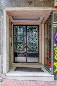 an entrance to a building with a glass door at Oscar - City Center Rooms Athens in Athens