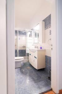 a bathroom with a toilet and a sink and a shower at oscar city room in Athens