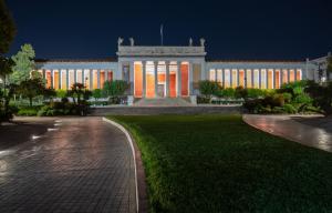 a building with lights on it at night at oscar city room in Athens