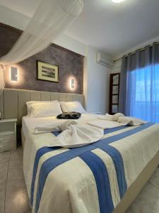 a bedroom with two beds with white and blue stripes at Karaoulanis Beach in Agios Ioannis Pelio +189 photos