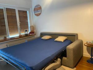 uma cama num quarto com um colchão azul em La perle em Annecy