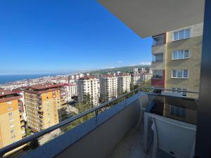 a balcony with a view of the ocean and buildings at Reis apart in Trabzon