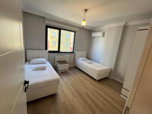 a room with two beds and a window at Reis apart in Trabzon