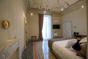 Posteľ alebo postele v izbe v ubytovaní Palazzo Sertorio Suites