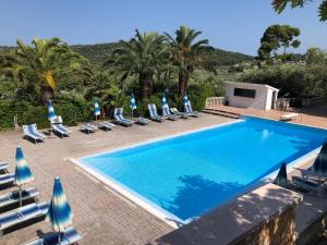 a swimming pool with chaise lounge chairs and a resort at Villa Amica in Vieste