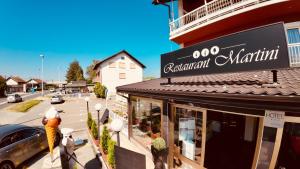 a restaurant with a sign on the side of a building at Hotel Martini Zagreb Hotel and Restaurant in Sesvete