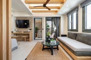 a living room with a couch and a table at Legato Spa Suites in Naxos Chora