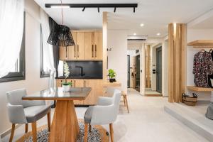 a kitchen and dining room with a table and chairs at Legato Spa Suites in Naxos Chora