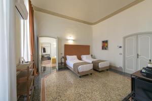 Posteľ alebo postele v izbe v ubytovaní Palazzo Sertorio Suites