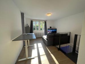 a living room with a couch and a television at House on historic city wall - Freihofapartments in Brugg