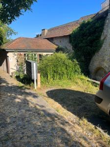 a house with a car parked on the side of a road at House on historic city wall - Freihofapartments in Brugg