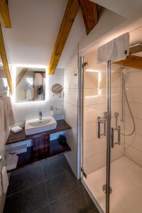 a bathroom with a sink and a shower at Swiss Inn & Apartments in Interlaken