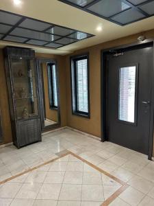 an empty room with a door and a tile floor at Central appartment 2 with parking in Larisa