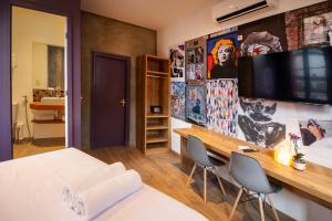 um quarto com uma cama e uma secretária com 2 cadeiras em Lobie Armazém São Joaquim no Rio de Janeiro