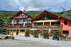 a large building with a balcony on top of it at Villaggio Gofree in Pragelato