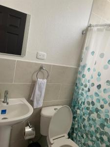 a small bathroom with a toilet and a sink at Turquesa 2 