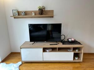 a flat screen tv sitting on top of a white entertainment center at Centar in Krapina