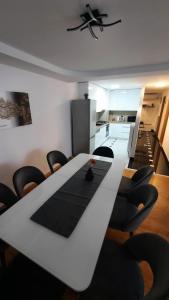 a dining room with a white table and black chairs at Centar in Krapina