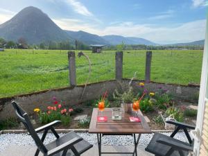 a patio with a table and chairs and a field at Römer Appartement mit sonniger Terrasse in Bad Reichenhall