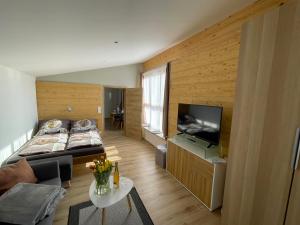 a small room with a bed and a television at Römer Appartement mit sonniger Terrasse in Bad Reichenhall