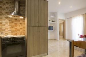 a kitchen with a refrigerator and a stove at Villa Giorgos in Kefalos