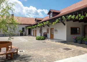 a courtyard of a building with a bench at Passero Holiday House in Moravske-Toplice