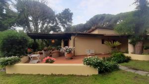 a house with a patio in the yard at Villa Elisa in Punta Ala