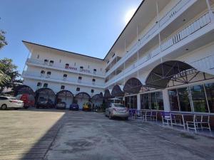 a large building with cars parked in front of it at ERAWAN PLACE in Mae Sot