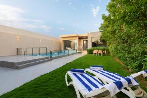 une cour avec deux chaises longues et une piscine dans l'établissement The Corner Hotel Resorts - Riyadh, à Riyad