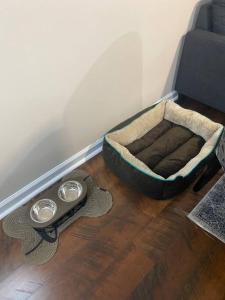 a dog bed sitting on the floor next to a couch at Cozy Bay Home Beach+Casino+More in Atlantic City
