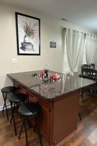 a kitchen island with bar stools in a room at Cozy Bay Home Beach+Casino+More in Atlantic City