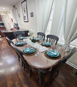 a dining room table with chairs and a wooden floor at Cozy Bay Home Beach+Casino+More in Atlantic City