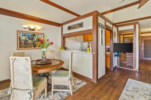 a kitchen and dining room with a table and chairs at Beautiful Poipu AC, Walk to Beach, Pool and Tennis KP117 in Koloa