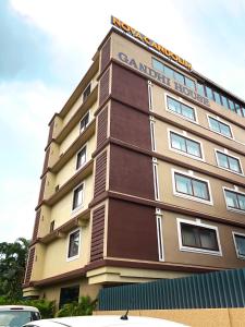 a tall building with a sign on top of it at Nova Candolim By Sudhanand, Candolim in Candolim